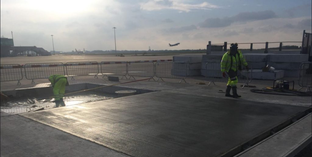 TAG operatives finishing a concrete bay at dawn on Stansted's main apron