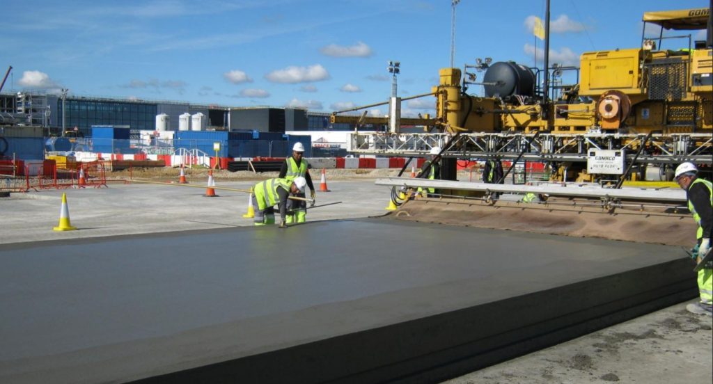 Slipform paving train laying concrete on the T2B apron at Heathrow
