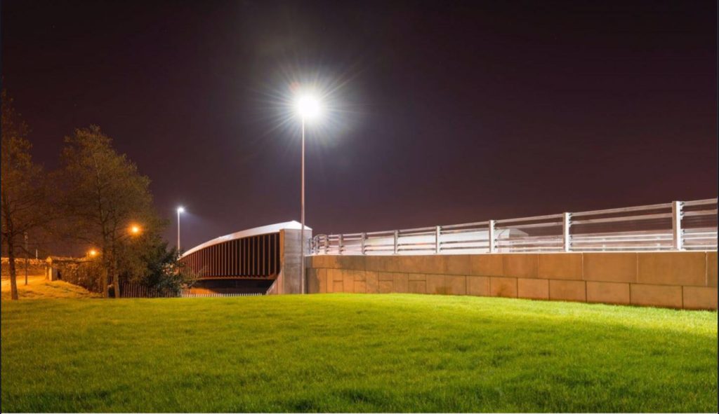 Completed Leigh Road bridge lit up at night in Slough