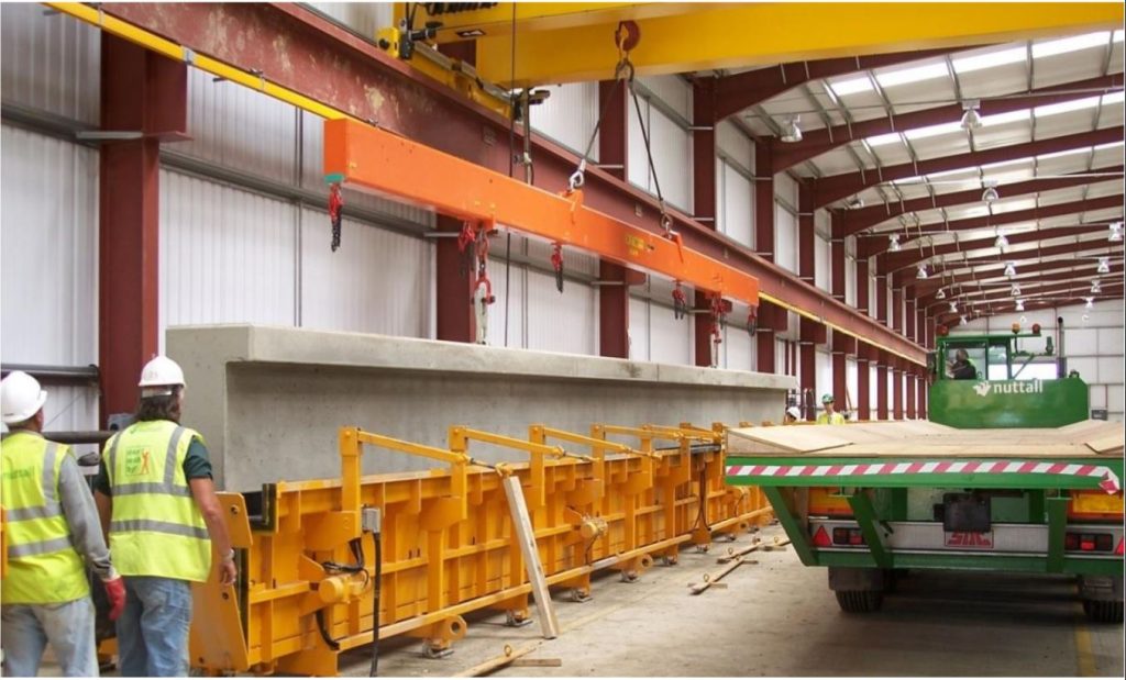 Precast concrete busway beam being moved in the casting factory