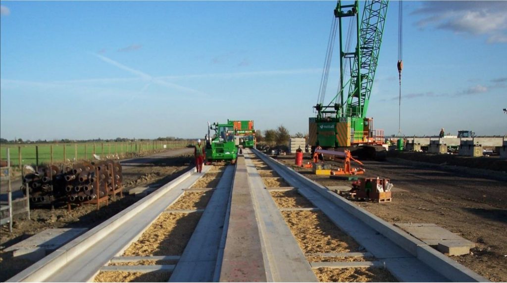 Crane placing precast guideway beams on the Cambridge Guided Busway