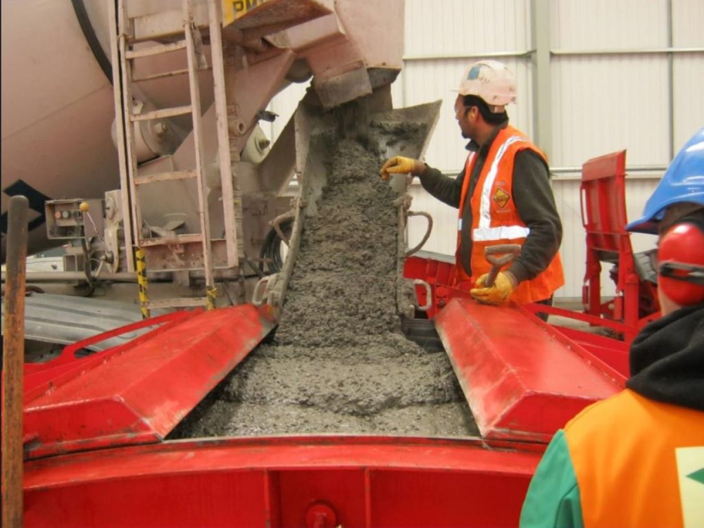 Operative pouring concrete into a tunnel segment mould for Crossrail