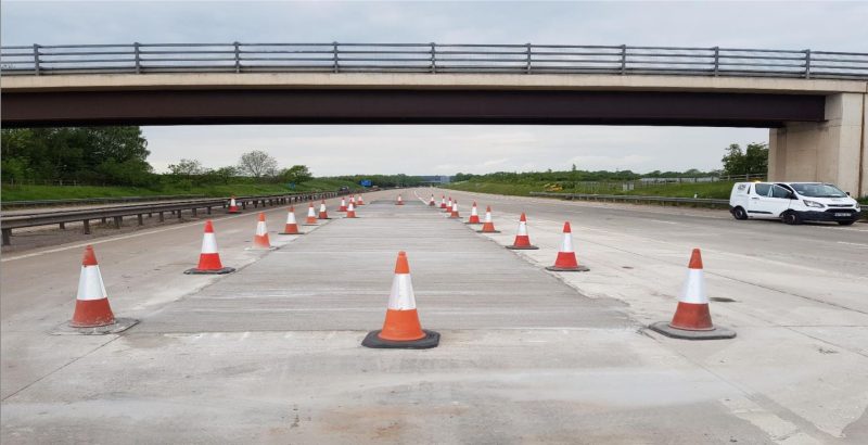 Finished concrete bays coned off under a bridge on the M54