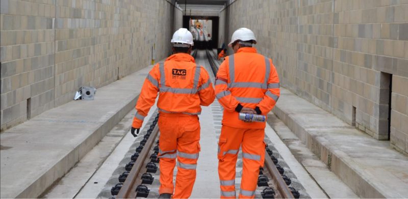 Two TAG operatives walking along new slab track in the Acton dive-under